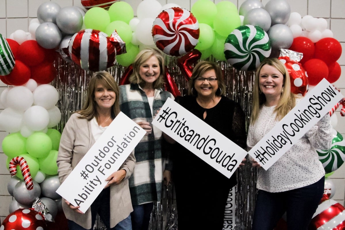 Four ladies in front of Christmas selfie station including Janice Rogers.
