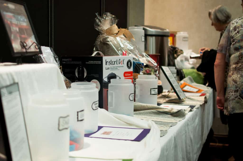 Kitchen items in a silent auction table holiday cooking show