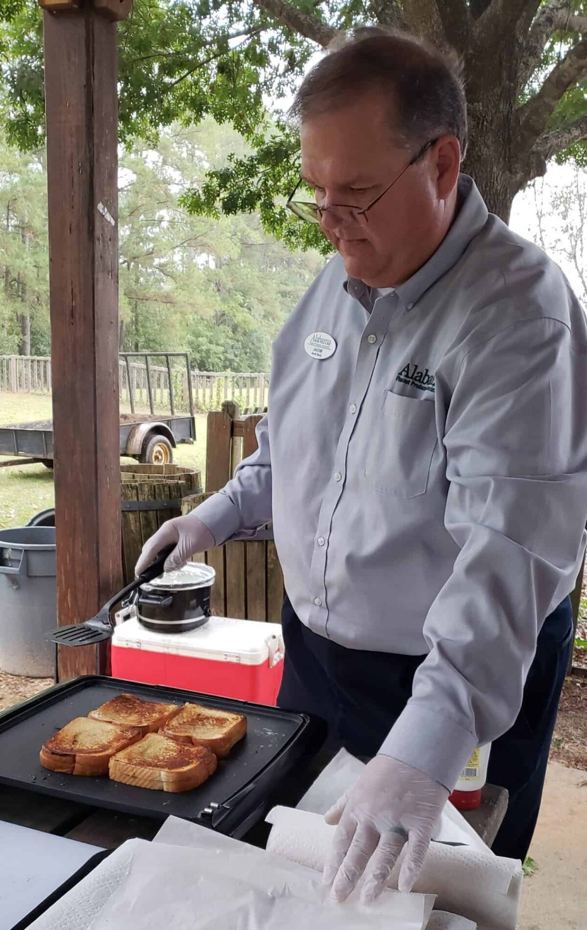 man making grilled peanut butter sandwiches on griddle