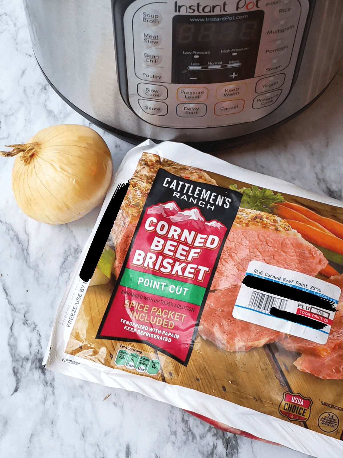 Package of corned beef and an onion in front of an Instant Pot.