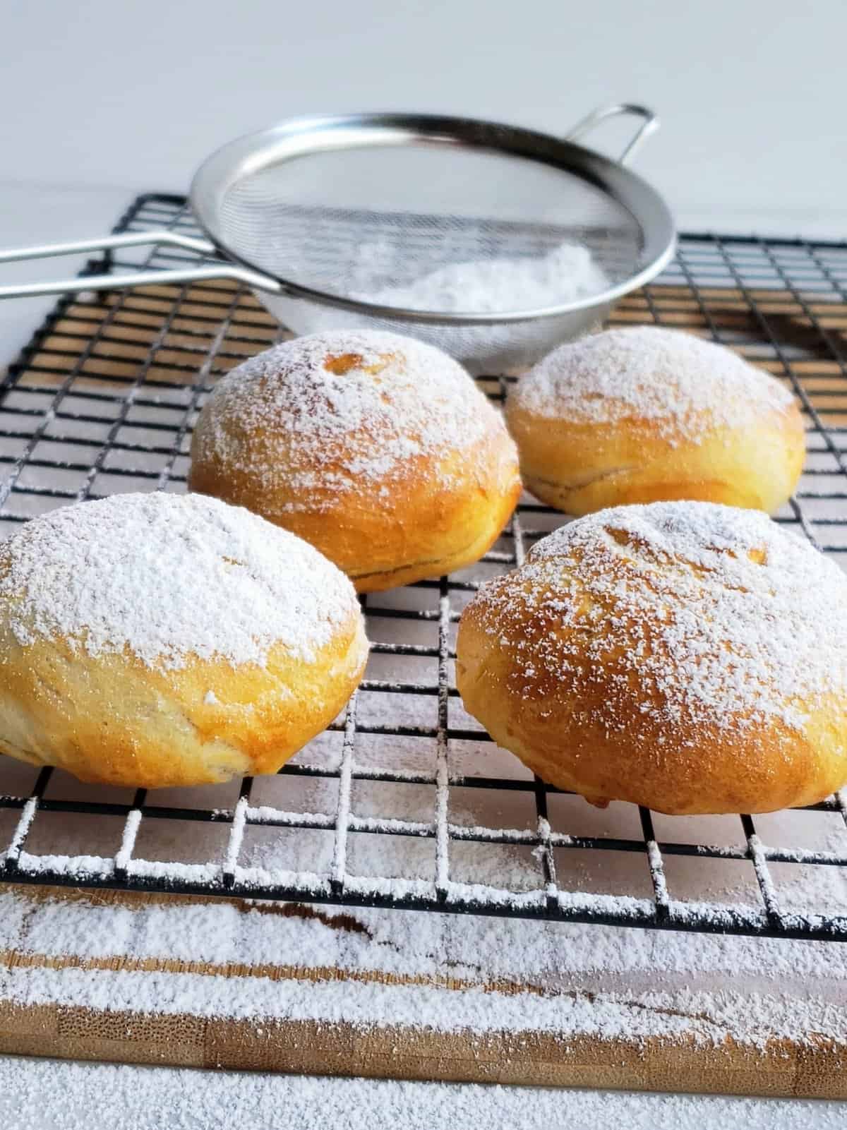 Air fryer Oreos sprinkled with powdered sugar on a wire rack