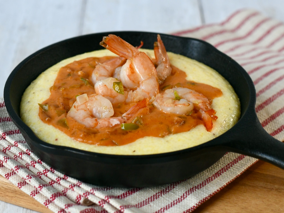 Shrimp and grits low country creole style in cast iron skillet.