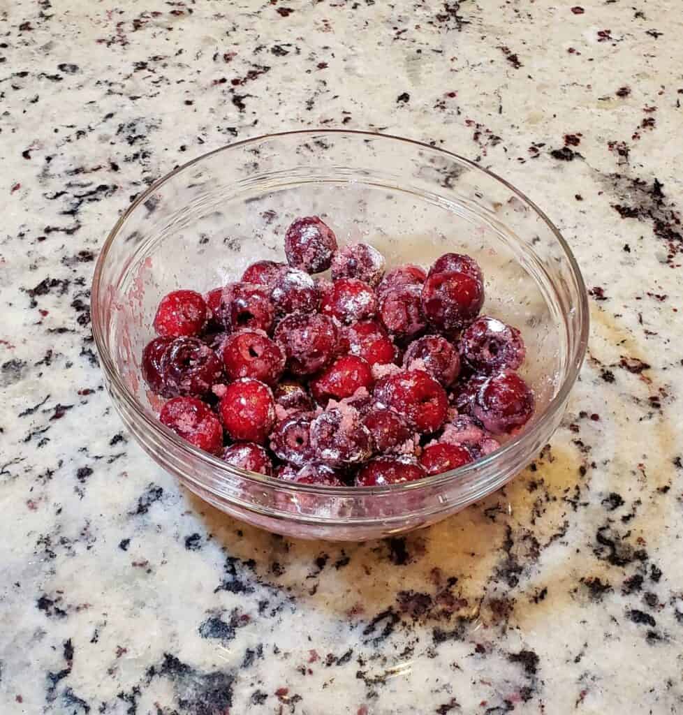 glass bowl of fresh cherries and sugar