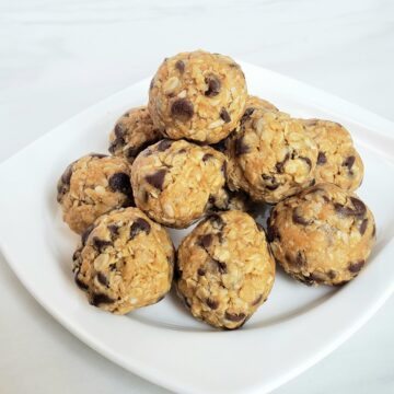 pyramid stack of peanut butter energy bites with chocolate chips on a white plate