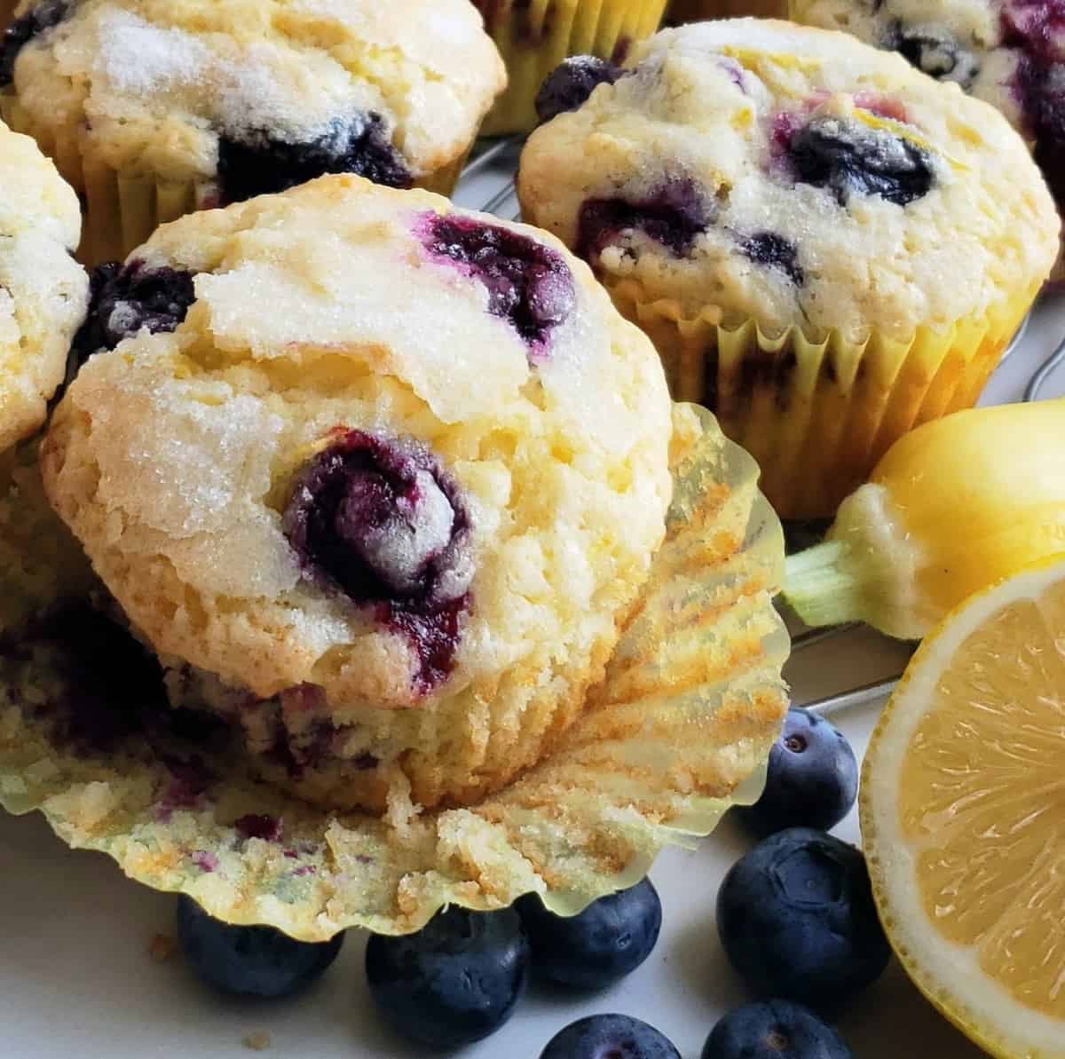 close up blueberry muffin with paper liner pulled away
