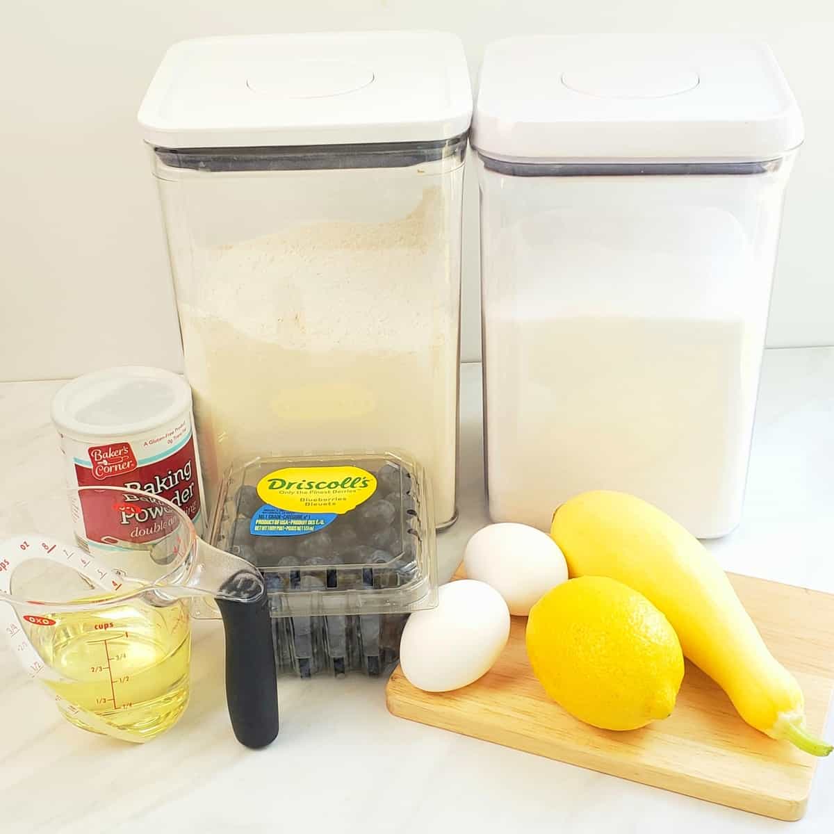 ingredients: flour, sugar, eggs, baking powder, blueberries, lemon, yellow squash, oil