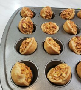 Peanut tarts tilted in mini muffin pan