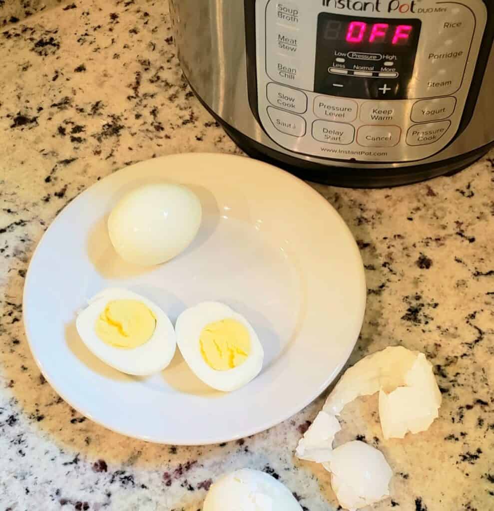 Boiled eggs, halved and peeled on a white plate