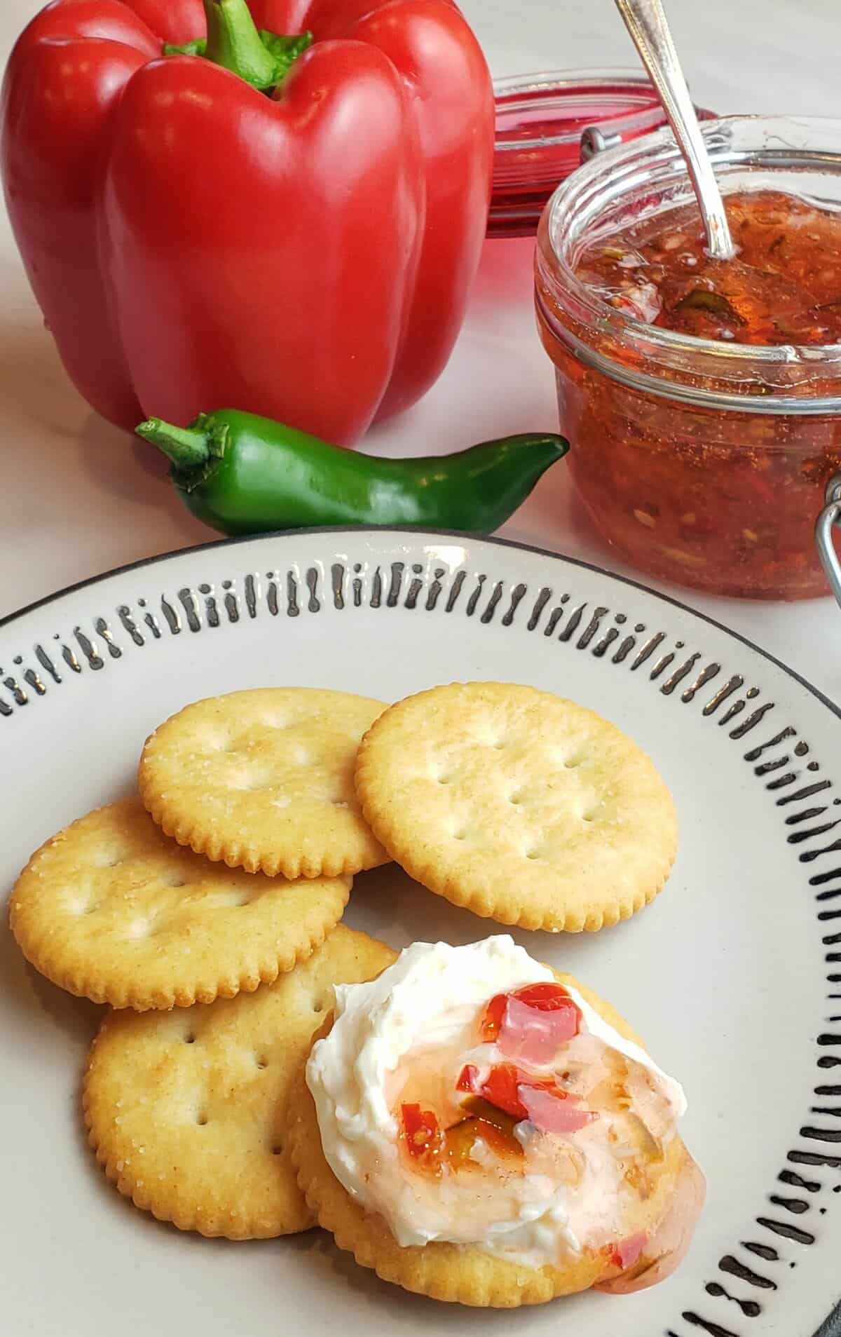 Freezer jalapeno pepper jelly on cream cheese spread on a cracker.