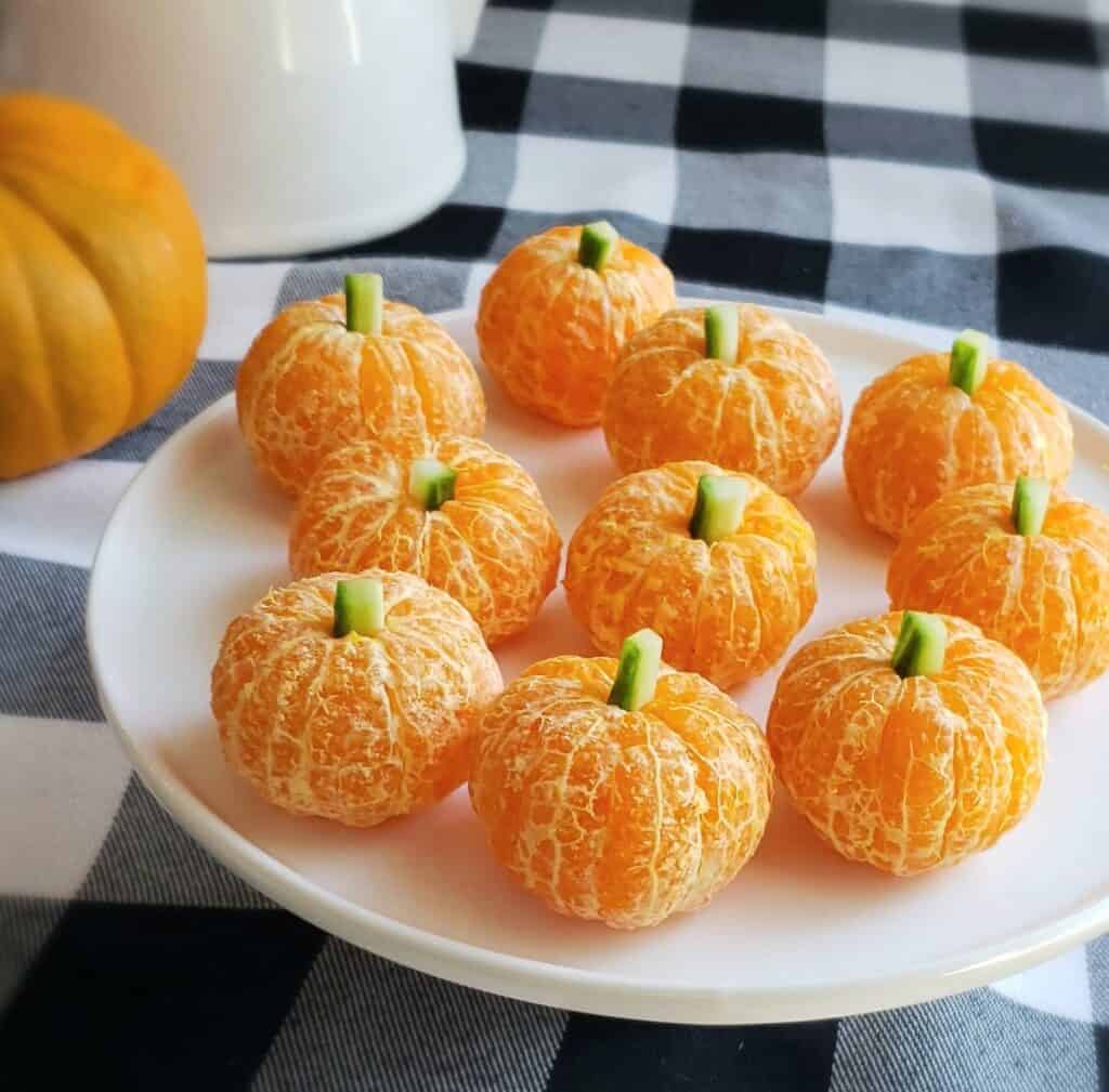 peeled clementine oranges with cucumbers in them to look like pumpkins