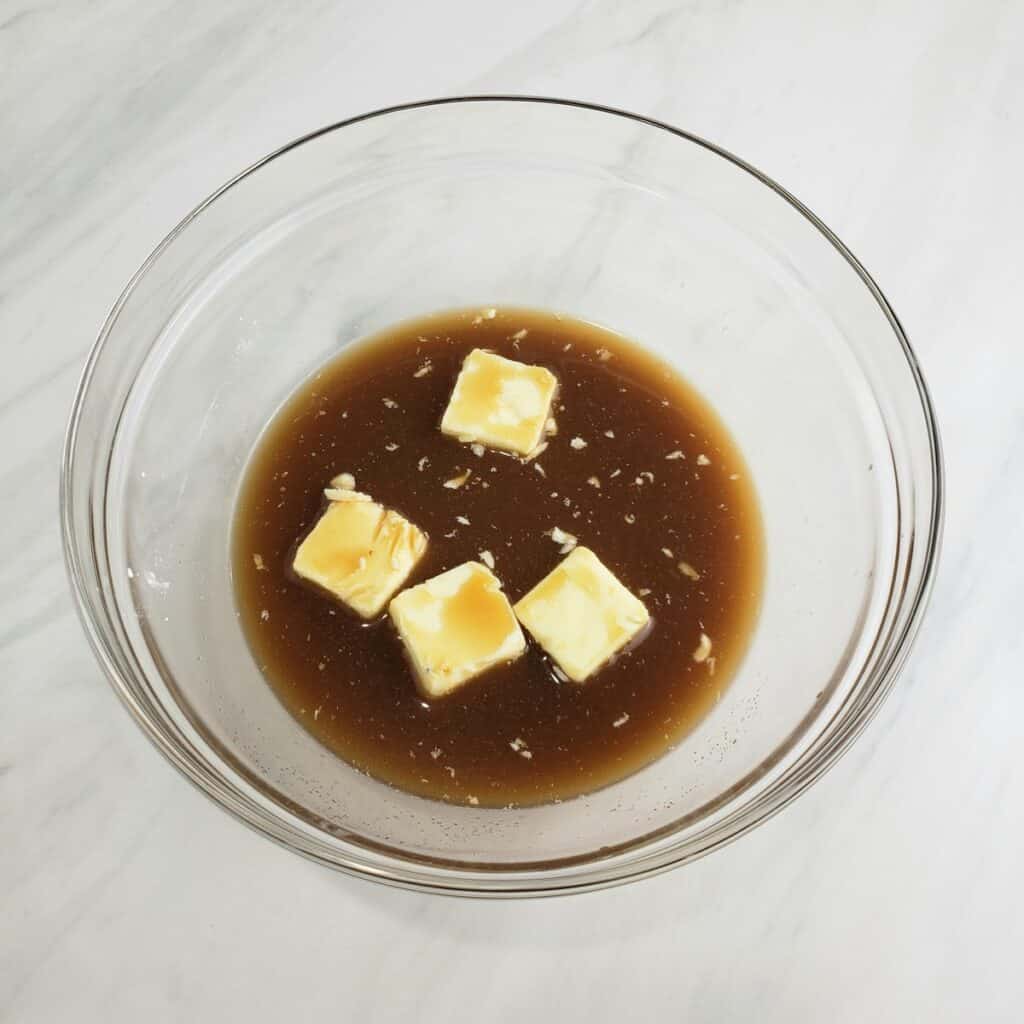 Combining butter and brown sugar and water in a glass bowl