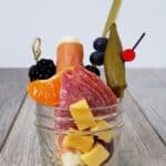 Small Mason jar filled with charcuterie snacks