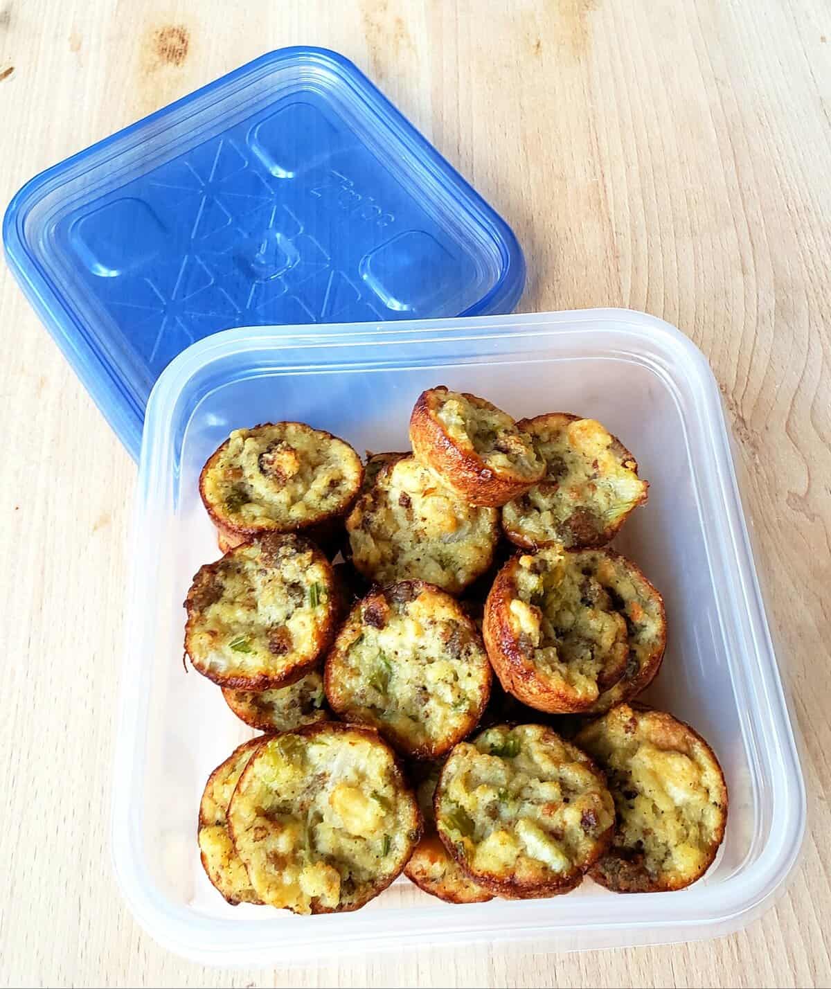 Cornbread dressing baked in muffin cups in a freezer container