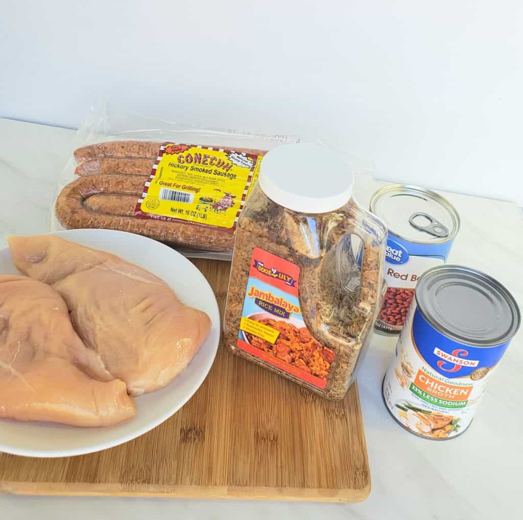 Ingredients: chicken breasts in a bowl, Dixie Lily jambalaya mix, smoked sausage, can of chicken broth, can of red beans