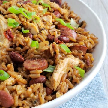 chicken sausage jambalaya with green onions in white bowl