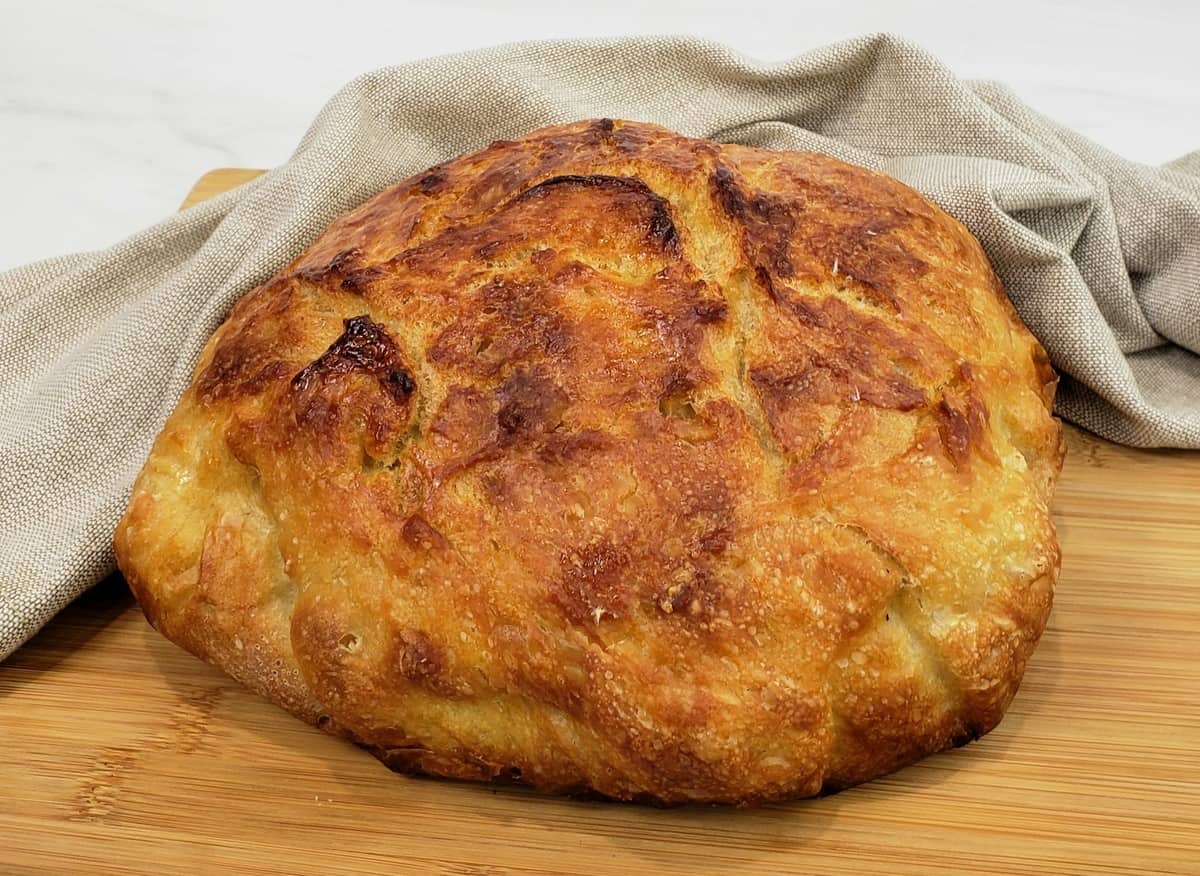 Round loaf artisan bread with grey cloth