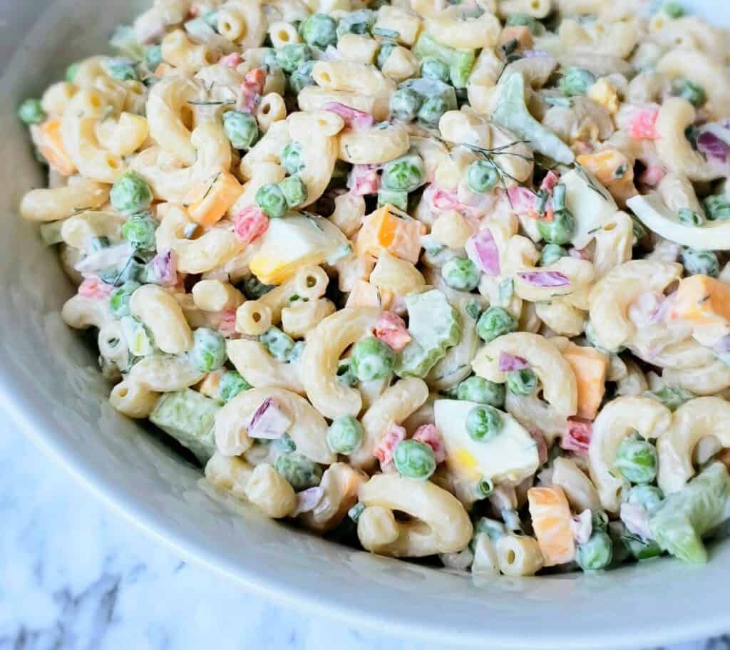 White bowl full of macaroni salad