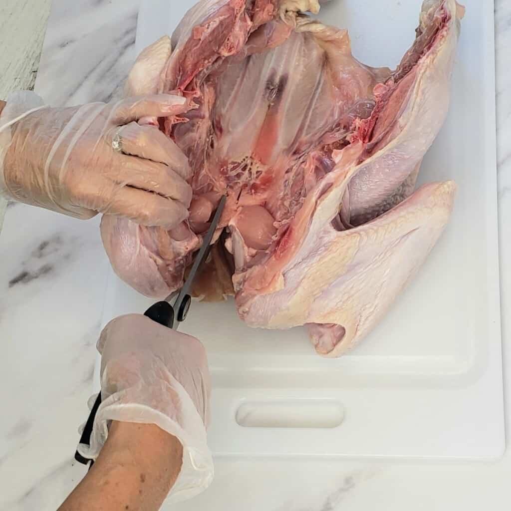 Process shot of cutting left inside turkey neck
