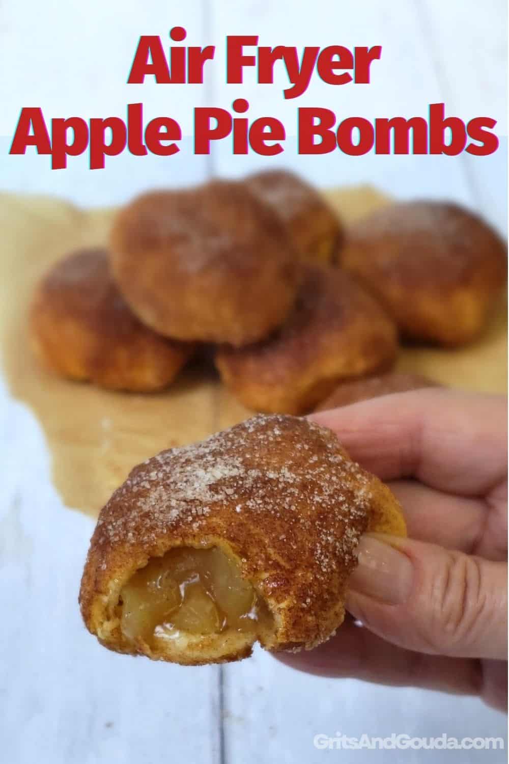 Apple Pie Bombs with bite out held by hand with text overlay.