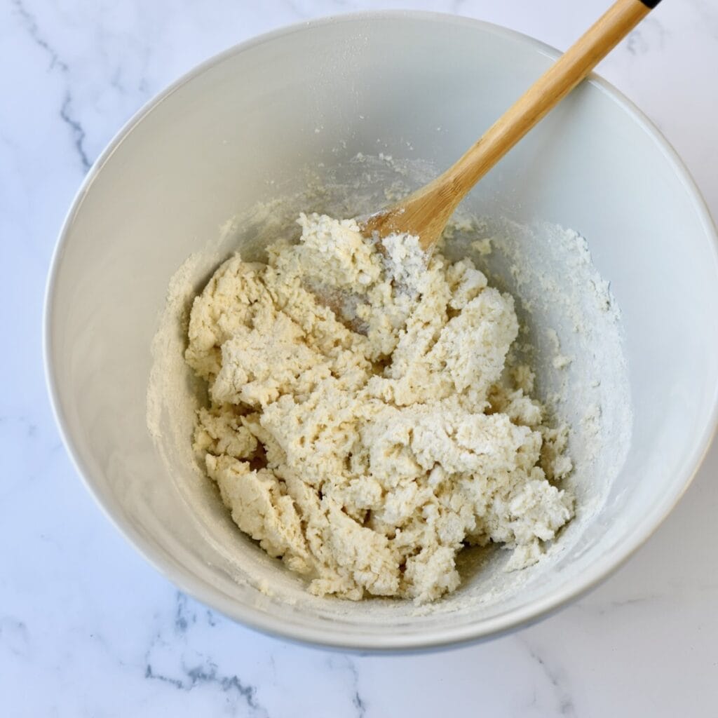 Biscuit dough in white bowl.