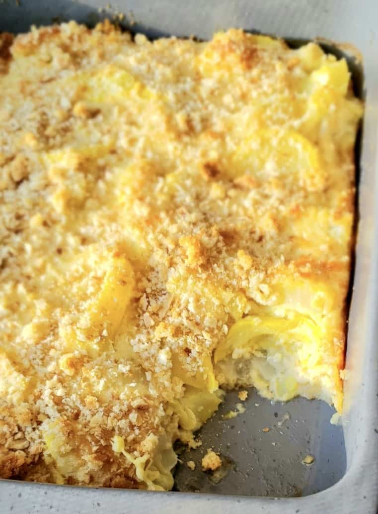 Easy Yellow Squash Casserole with scoop out of gray dish.