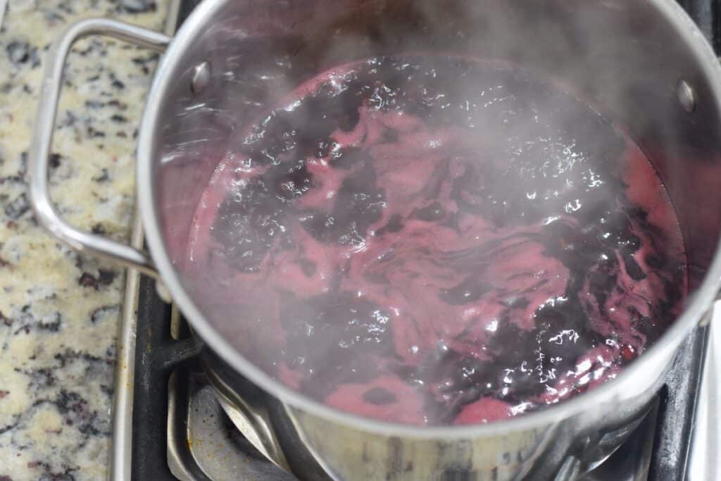Fresh blackberry jelly boiling in pot