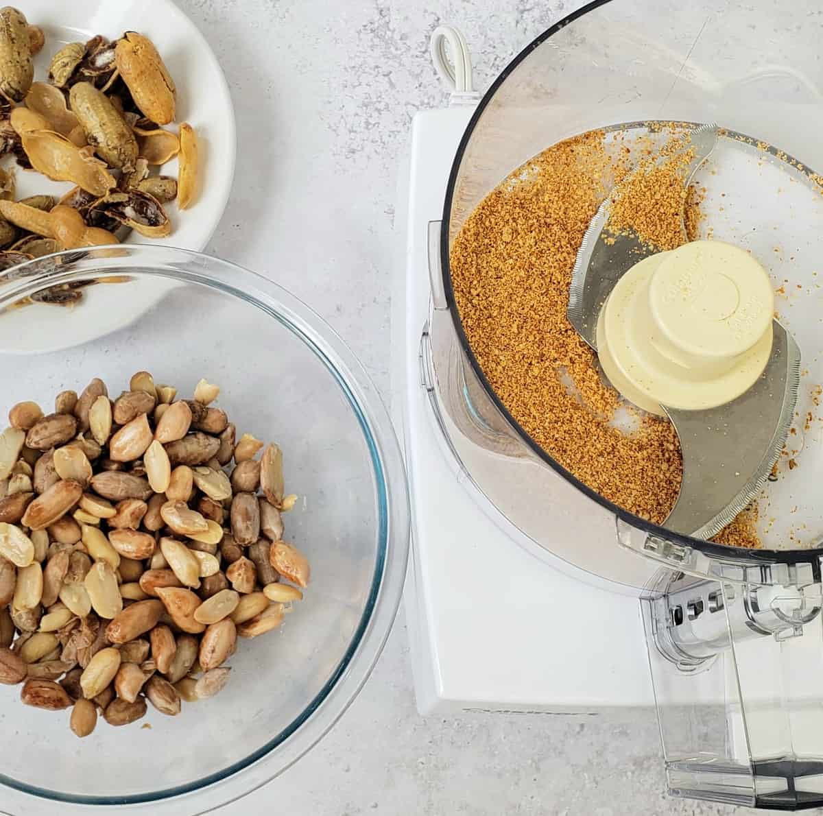 Process shot for Boiled Peanut Hummus: shelled boiled peanuts next to food processor.