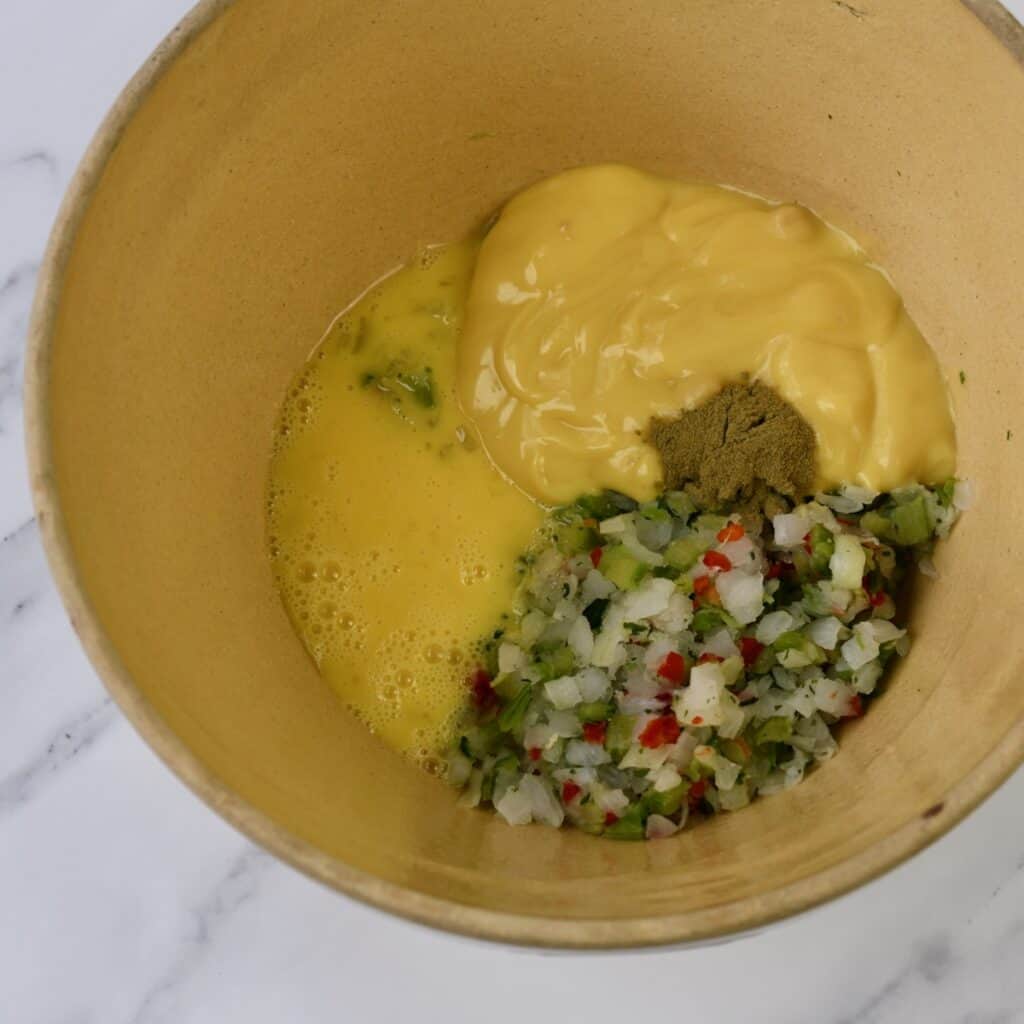 Ingredients for Crockpot Chicken Dressing in large tan bowl.
