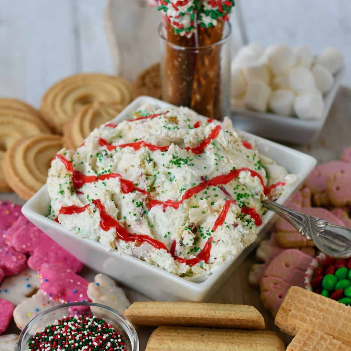 Close up view of Little Debbie Christmas tree cake dip in middle of dessert board.