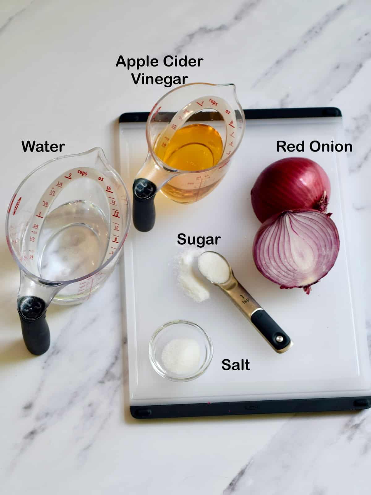 picked red onion recipe ingredients set out on a board