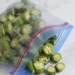 A Ziploc freezer bag filled with slices of whole okra.