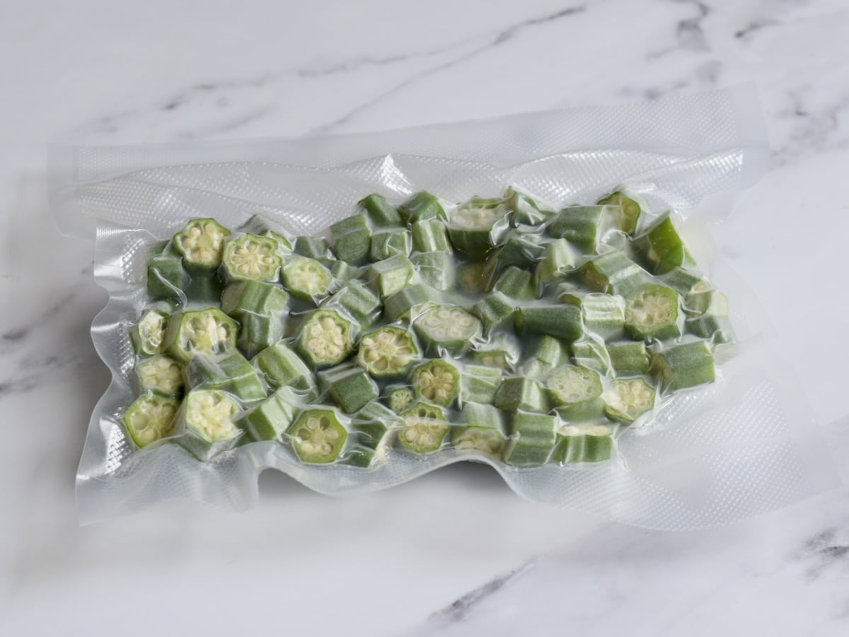 Slices of frozen okra in a vacuum sealed bag.