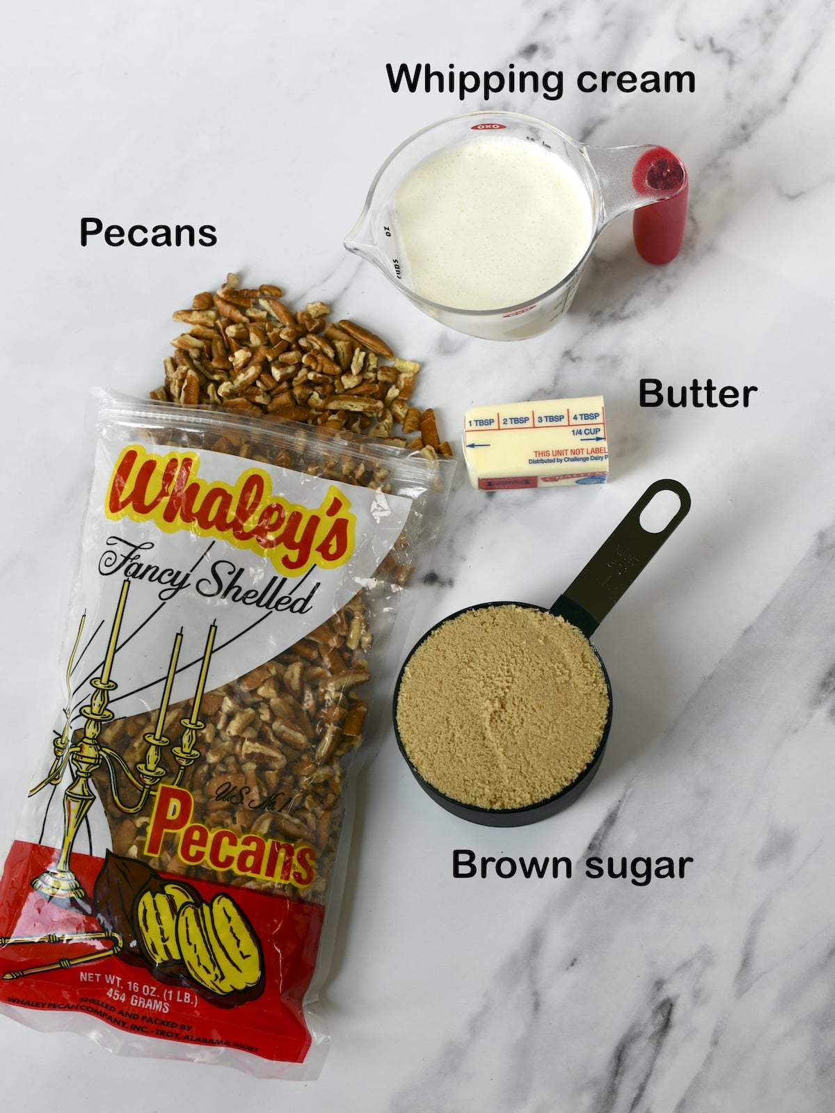 Ingredients for easy praline pecan sauce: pecans, brown sugar, whipping cream, butter.