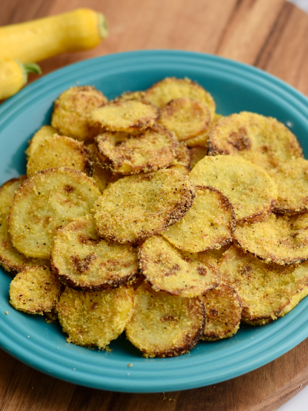 Overhead view of blue plate of air fryer fried yellow squash.