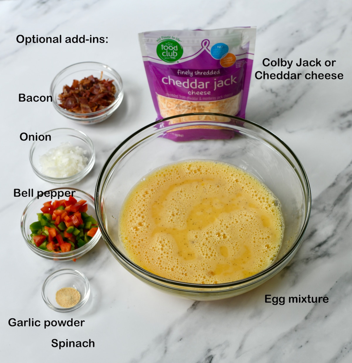 Optional ingredients to add in to a sheet pan omelette: garlic powder, bacon, bell pepper, onion, spinach, cheese.