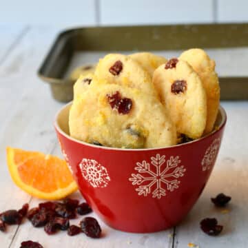 Cranberry cookies in a red snowflake bowl.