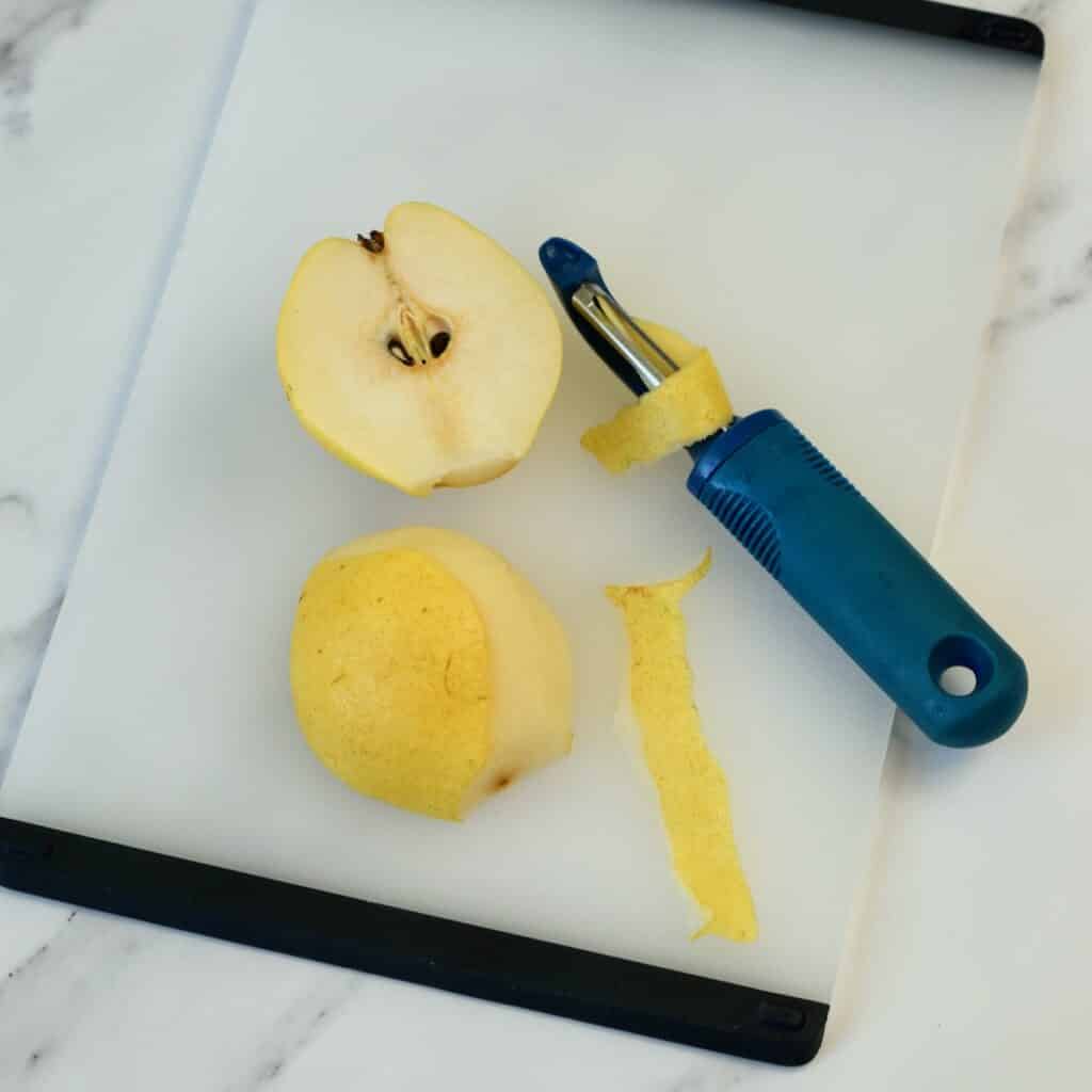 Using a peeler to remove pear skins.