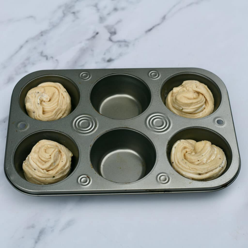 unbaked Cruffins in muffin pans. 