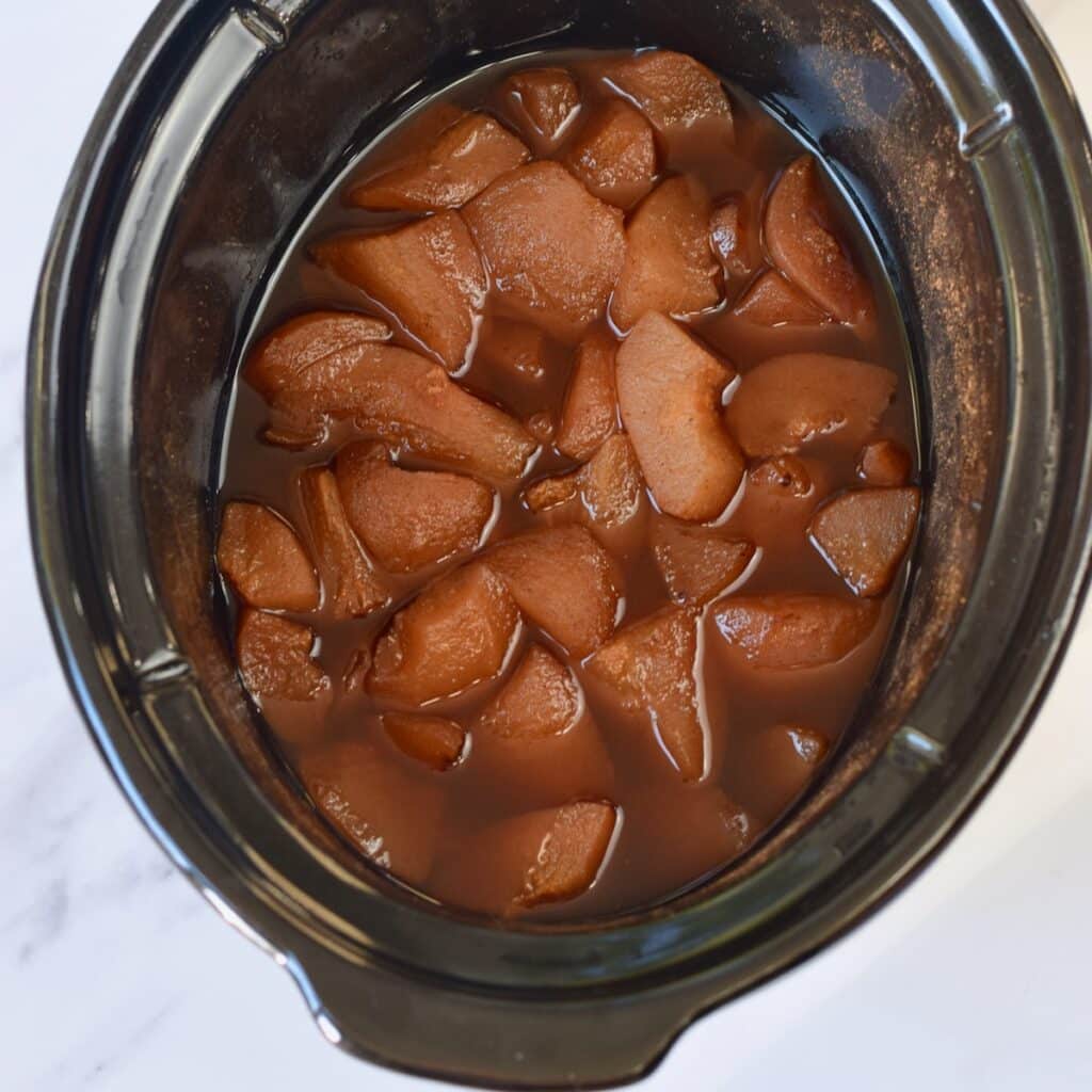Cooked pears in a crock pot.