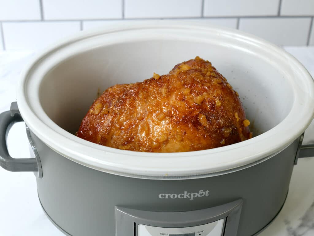 Fully cooked pineapple ham in the slow cooker.