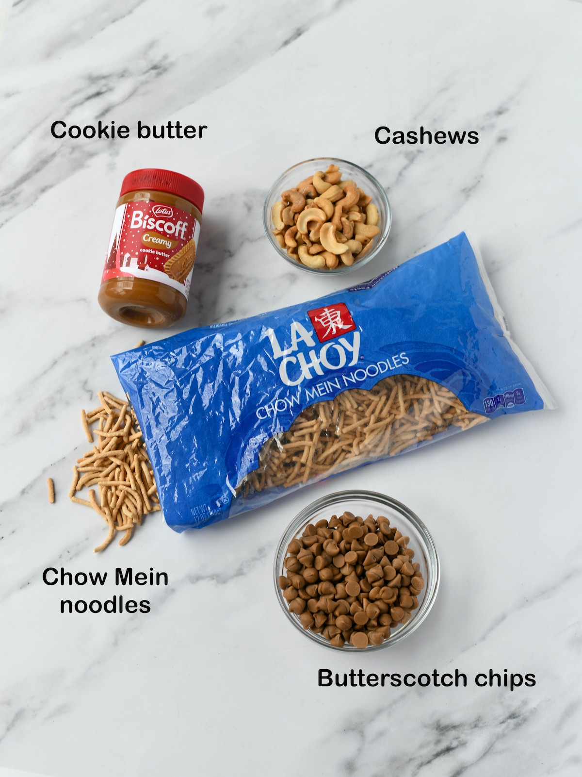 Ingredients for Cookie Butter Haystacks candy: chow mein noodles, Biscoff, cashews, butterscotch chips.
