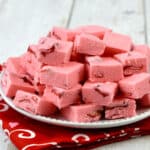 Strawberry fudge with freeze dried strawberries on a red cloth.