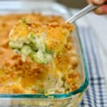 Creamy chicken broccoli rice casserole scooped out of dish.