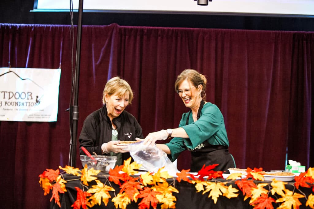 two women on stage cooking.