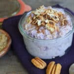 Purple sweet potato overnight oats in a Weck jar with pecans on the side.