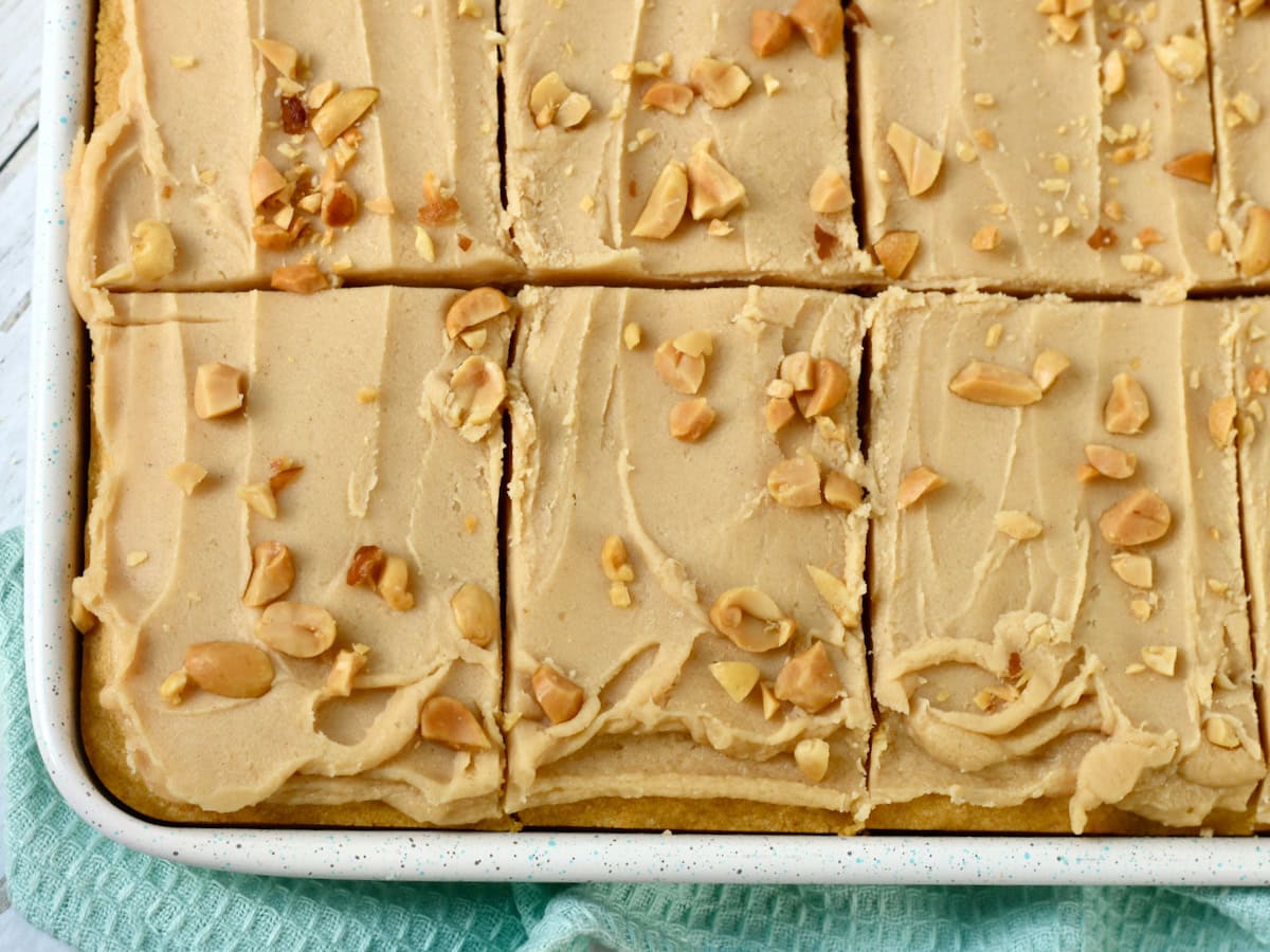 Peanut Butter Sheet Cake with cake mix scored into slices in the pan.