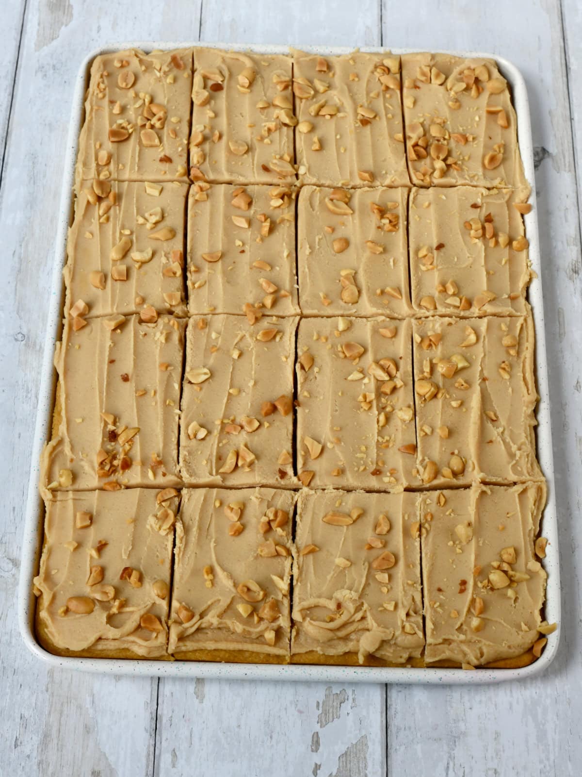 Peanut Butter Sheet Cake with cake mix in 15 x 10 inch sheet pan with frosting and peanuts.