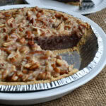 No bake chocolate pie in graham cracker crust with pecans and coconut.