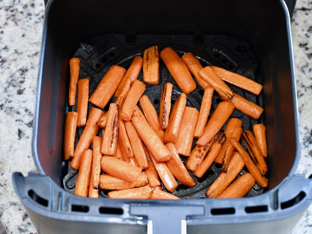 Air-fried honey roasted carrots inside the air fryer basket