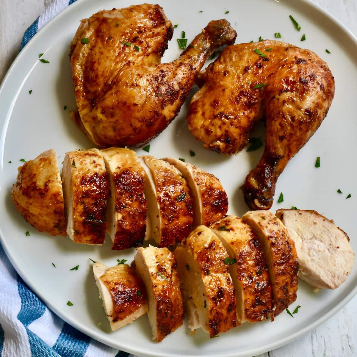 A air fried roasted chicken cut up into pieces on a plate.
